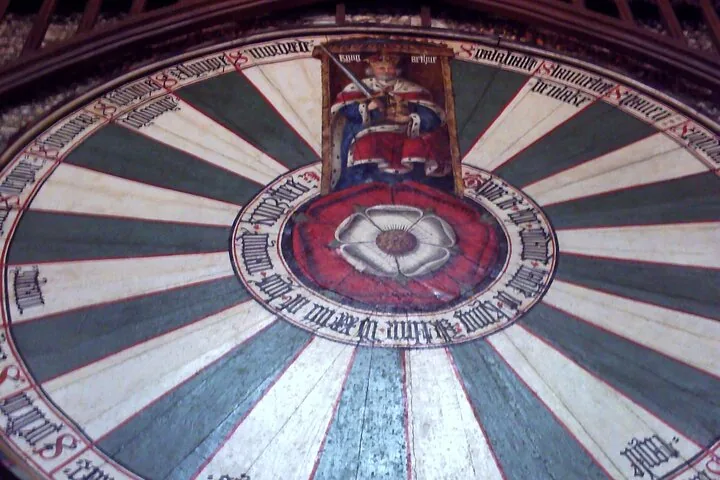 A circular mural depicting King Arthur and his knights.
